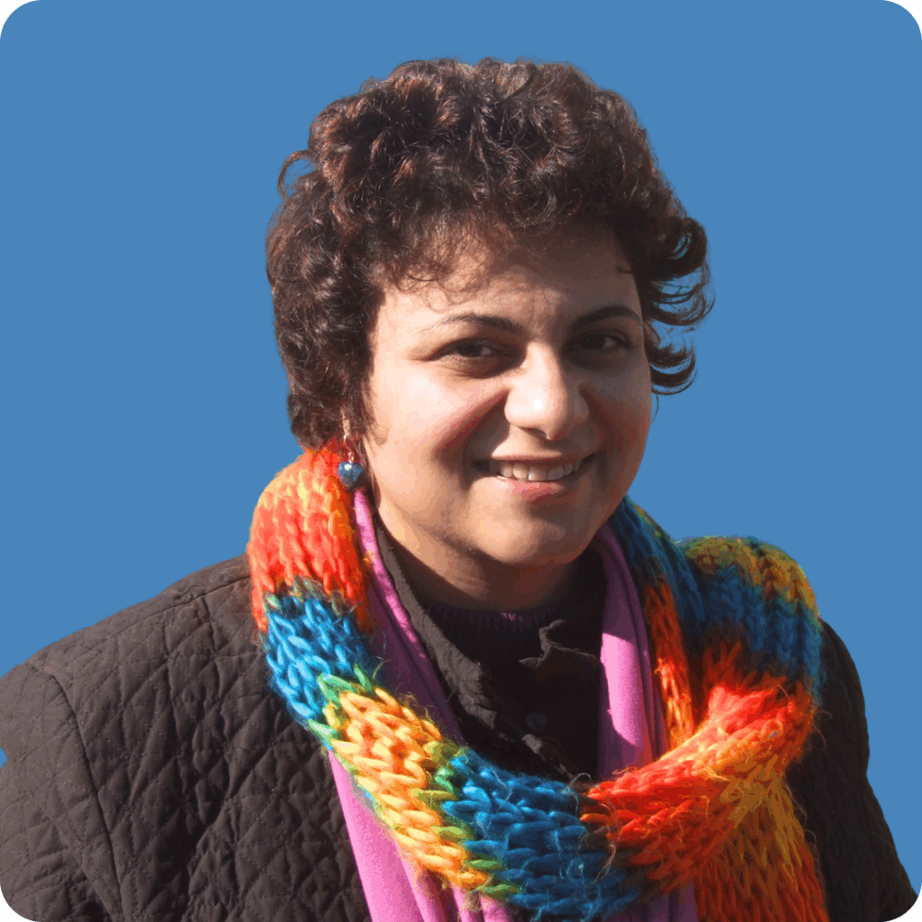 Profile photo of Leila smiling, on a solid blue background.