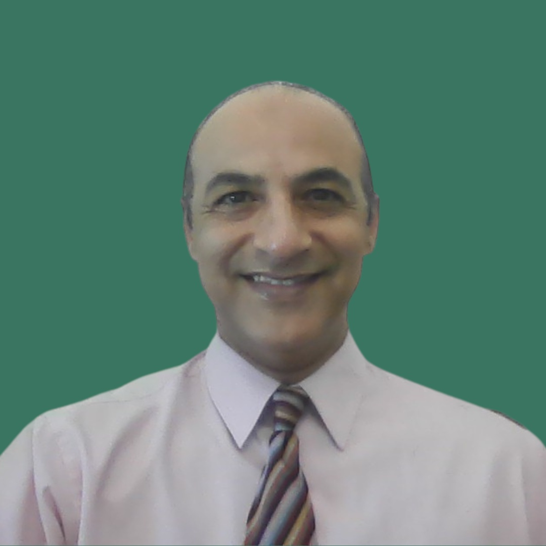 Smiling man in a pink shirt and striped tie, posing for a headshot against a solid green background.
